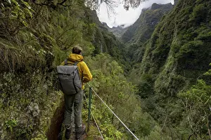 Levada Do Caldeirao Verde Prints: Hikers on a narrow path along a levada