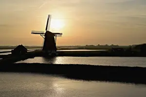 Benelux Countries Landmark Prints: Historic windmill in the light of the setting sun