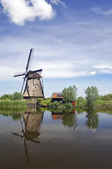 Uninhabited Windmill Structure Prints: Historic windmill reflected in a canal