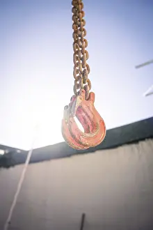 Construction Site Germany Prints: Hook hanging on chain on construction site