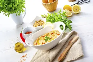 Healthy Snack Ideas Prints: Hummus paste with lemon and chilli on a white background