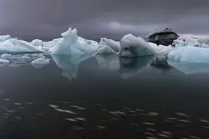Glacier Lake In Europe Prints: Icebergs under dark clouds, dramatic and threatening