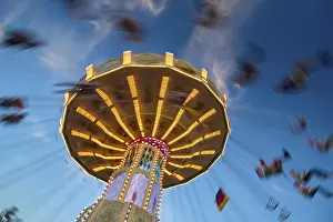 Southern Germany Fairground Scene Prints: An illuminated carousel at dusk