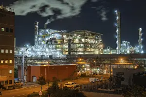 Prints of Illuminated industrial plant at night with smoking chimneys and vehicles on the road in the foreground, Mannheim, Germany Mannheim Prints: Industrial Plant at Night, Mannheim Germany Print