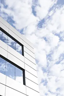 Urban Cityscape View Prints: An image capturing a segment of a modern building's exterior featuring angular white panels