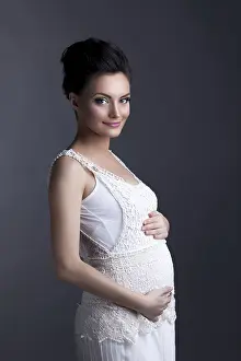 Expectant Mother Prints: Image of charming expectant mother posing looking at camera