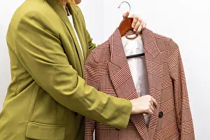 Fashion Consulting Services Prints: An image consultant assists a client in selecting a stylish jacket