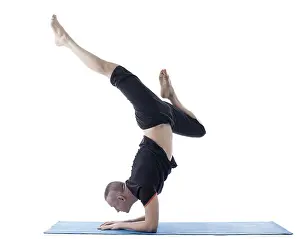 Studio Shot Of A Yogi Prints: Image of flexible man posing in difficult yoga pose