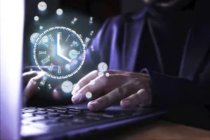 Online Business Professional Prints: Image of a man using the computer with a clock indicating the time of use of the pc