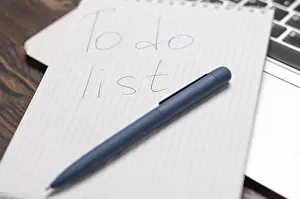Creative Workspace Inspiration Prints: Image of a notebook with a pen lying on a laptop