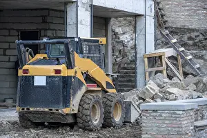 Building Site Machinery Prints: Image of skid loader working on building construction