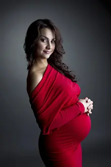 Newborn Baby Prints: Image of smiling expectant mother posing at camera