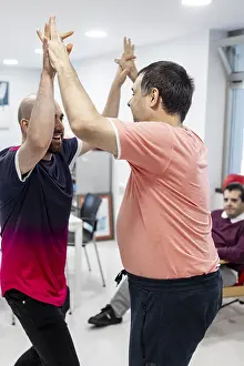 Mental Health Support Prints: Two individuals engage in a supportive high-five activity