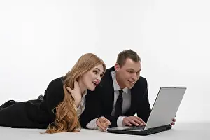Teamwork And Technology Prints: Two individuals engaged in a collaborative activity