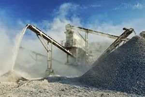 Open Pit Mining Prints: Industrial background, crusher rock stone crushing machine at open pit mining and processing plant for crushed stone
