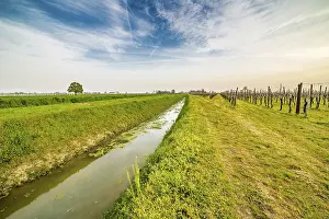 Deserted Farmland Images Prints: Irrigation canal runs through the fields in the countryside of Romagna