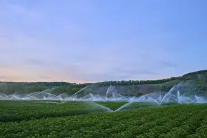 Lower Franconia Landscape Photography Prints: Irrigation systems work under a blue evening sky on vast fields