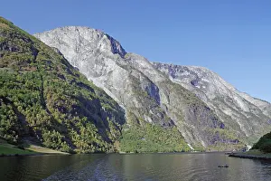 Uninhabited Norwegian Coastline Prints: Kayakers in front of high cliffs