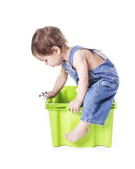 One Person Isolated On White Prints: Kid plays with plastic container isolated on white
