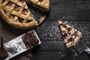 Kitchen Table Setup Prints: Kitchen table with a whole apple pie and one slice on a knife
