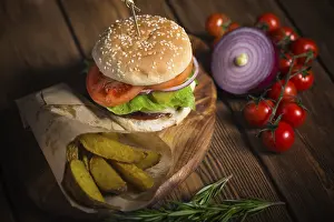 Wooden Surface Meal Prints: Large appetizing burger with beef