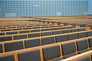 Sacred Building Structure Prints: Large auditorium with geometric patterns on the wall and many rows of seats