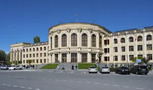 Flag Waving In The Wind Prints: A large classical building with flags
