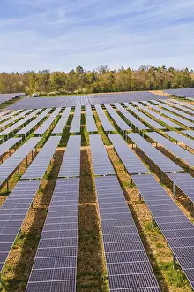 Solar Panel Installation Prints: Large number of solar modules in a row of fields spanning extensive terrain