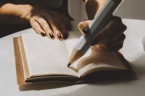 Time Management Concept Prints: Large pencil is standing on a sheet of a notebook