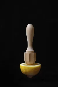 Vitamin Rich Fruits Image Prints: Lemon and lemon squeezer against a black background