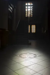 Deserted Hallway Prints: Light falls through a window into a dark corridor