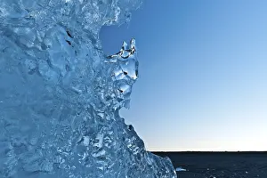 Evening Light On Water Prints: Light reflections in a stranded piece of iceberg after sunset
