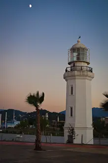 Lighthouse Architecture Prints: Lighthouse on the beach, against the backdrop of mountains