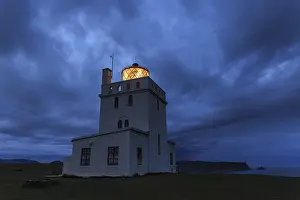 Atmospheric Coastal Views Prints: Lighthouse at the coast, twilight