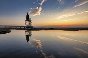 Lighthouse At Sunset Prints: Lighthouse at sunset is reflected in water