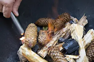 Outdoor Cooking Methods Prints: Lighting a fire for a barbecue