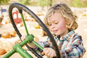 Pumpkin Patch Fun Prints: Little boy having fun in A tractor in a rustic ranch setting at the pumpkin patch