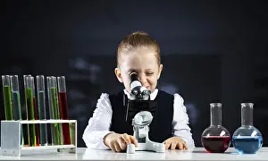 Little Scientist Prints: Little scientist looking through microscope in classroom
