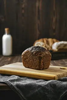 Black Table Setup Prints: Loaf of artisan rye bread on a table