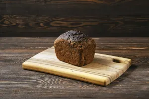 Black Table Setting Prints: Loaf of artisan rye bread on a table