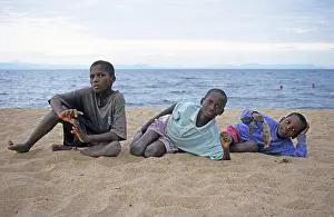 East African Landscapes Prints: Three local boys posing for the camera on the beach