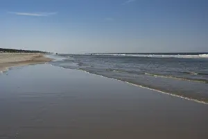 Sandy Coastline Europe Prints: Long sandy beach with outgoing waves