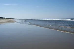 Sandy Coastline Europe Prints: Long sandy beach with outgoing waves