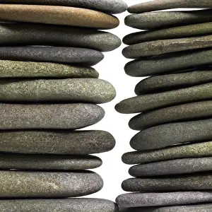 Deserted Beach Landscape Prints: Low angle view of two flat pebble stone stacks in light back