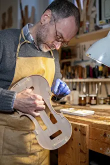 Images Dated 3rd December 2024: Luthier Restoring a Violin in Workshop Print