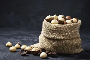 Black Table Setup Prints: Macadamia nuts in a bag on a black table