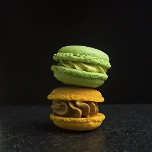 Foodstuff Photography Prints: Two macarons on a black background