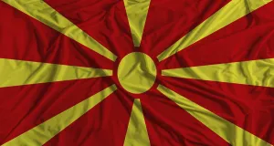 Prints of Macedonian flag with fabric texture background. National flag of North Macedonia with cloth texture North Macedonia Prints: Macedonian Flag Print with Fabric Texture Background