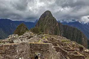 Ancient Inca Architecture Prints: Machu Picchu with dramatic cloudscape and visible mountain