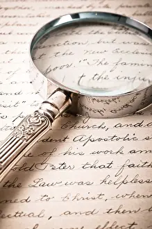 Close Up Detail View Photo Prints: A magnifying glass over antique cursive script